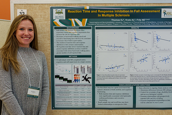 Graduate student with research poster
