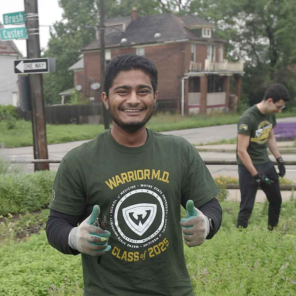 Two students volunteering in an urban garden